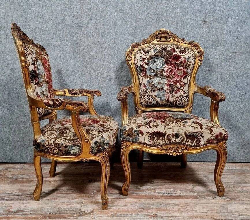 Pair of carved and gilded cabriolet armchairs in the Louis XV style.