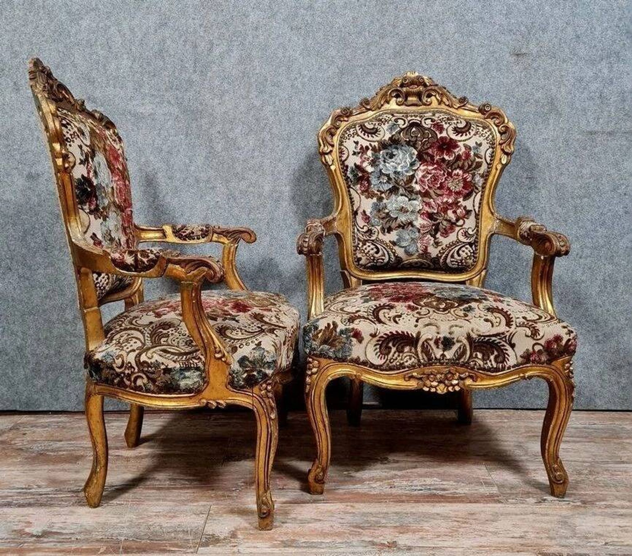 Pair of carved and gilded cabriolet armchairs in the Louis XV style.