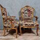 Pair of carved and gilded cabriolet armchairs in the Louis XV style.