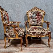 Pair of carved and gilded cabriolet armchairs in the Louis XV style.