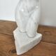 Sculpture of a female torso in white marble.