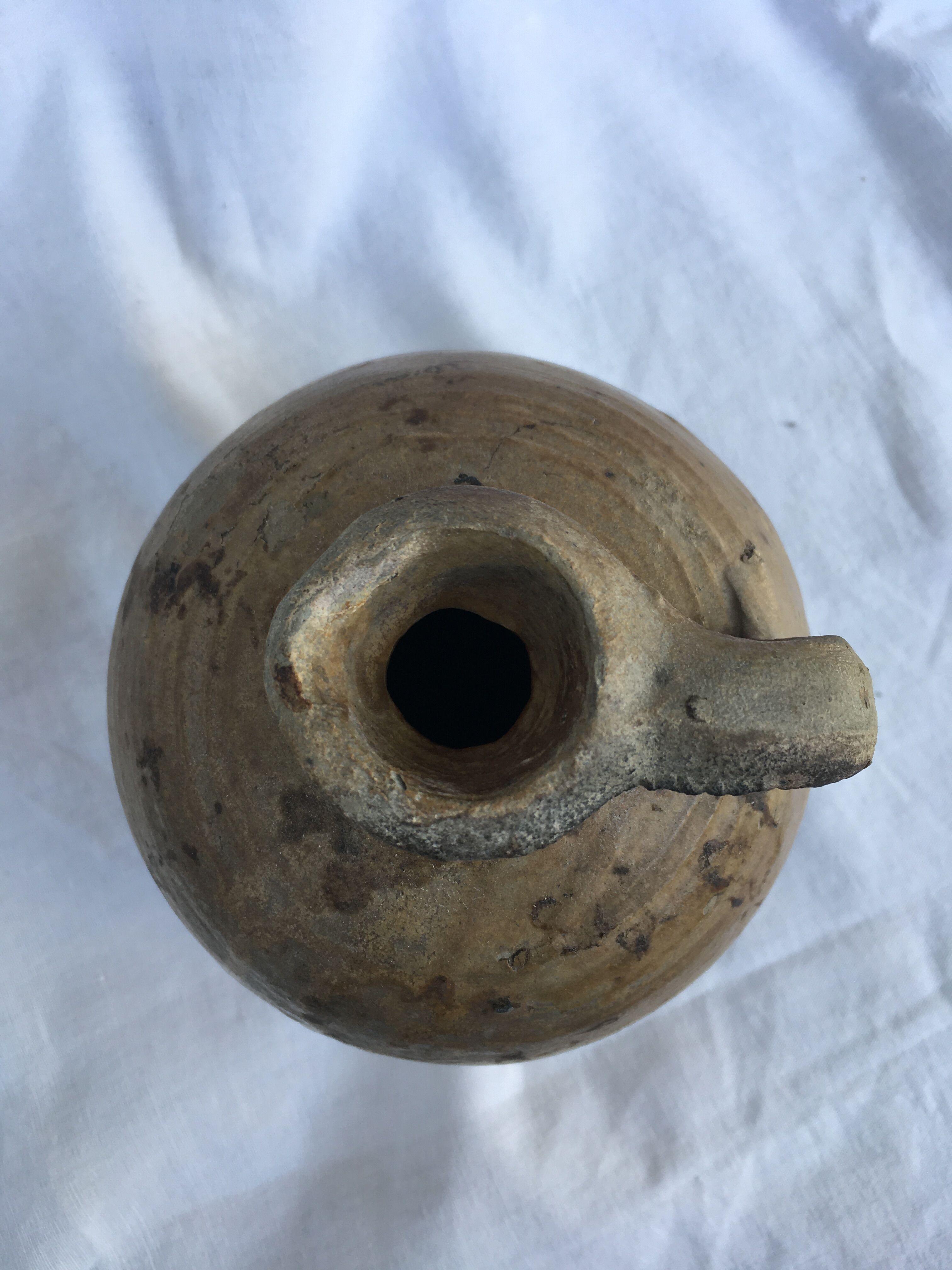 Ancient jug in glazed sandstone