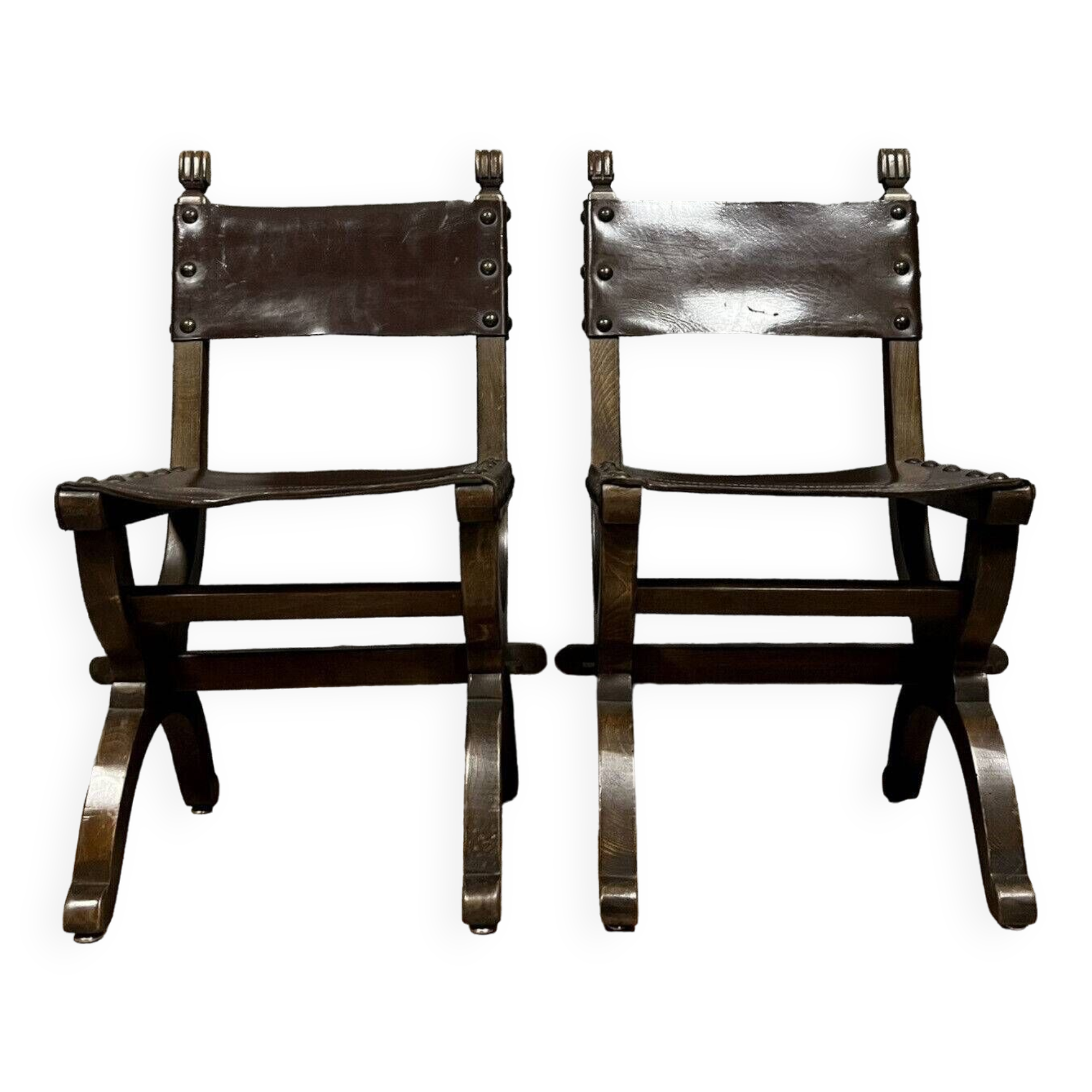 Pair of medieval style chairs in solid wood and leather, 19th century, circa 1850