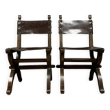 Pair of medieval style chairs in solid wood and leather, 19th century, circa 1850