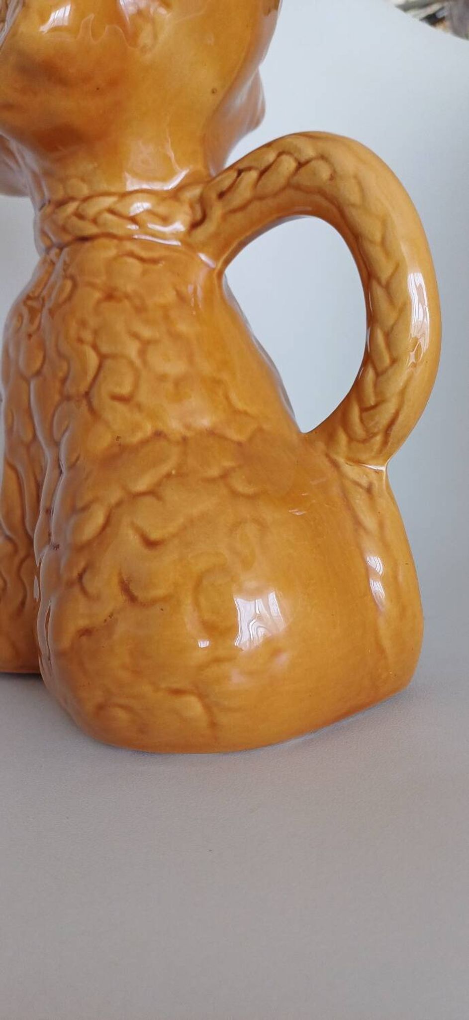 Ancient ceramic pitcher in the shape of a poodle.