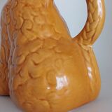Ancient ceramic pitcher in the shape of a poodle.