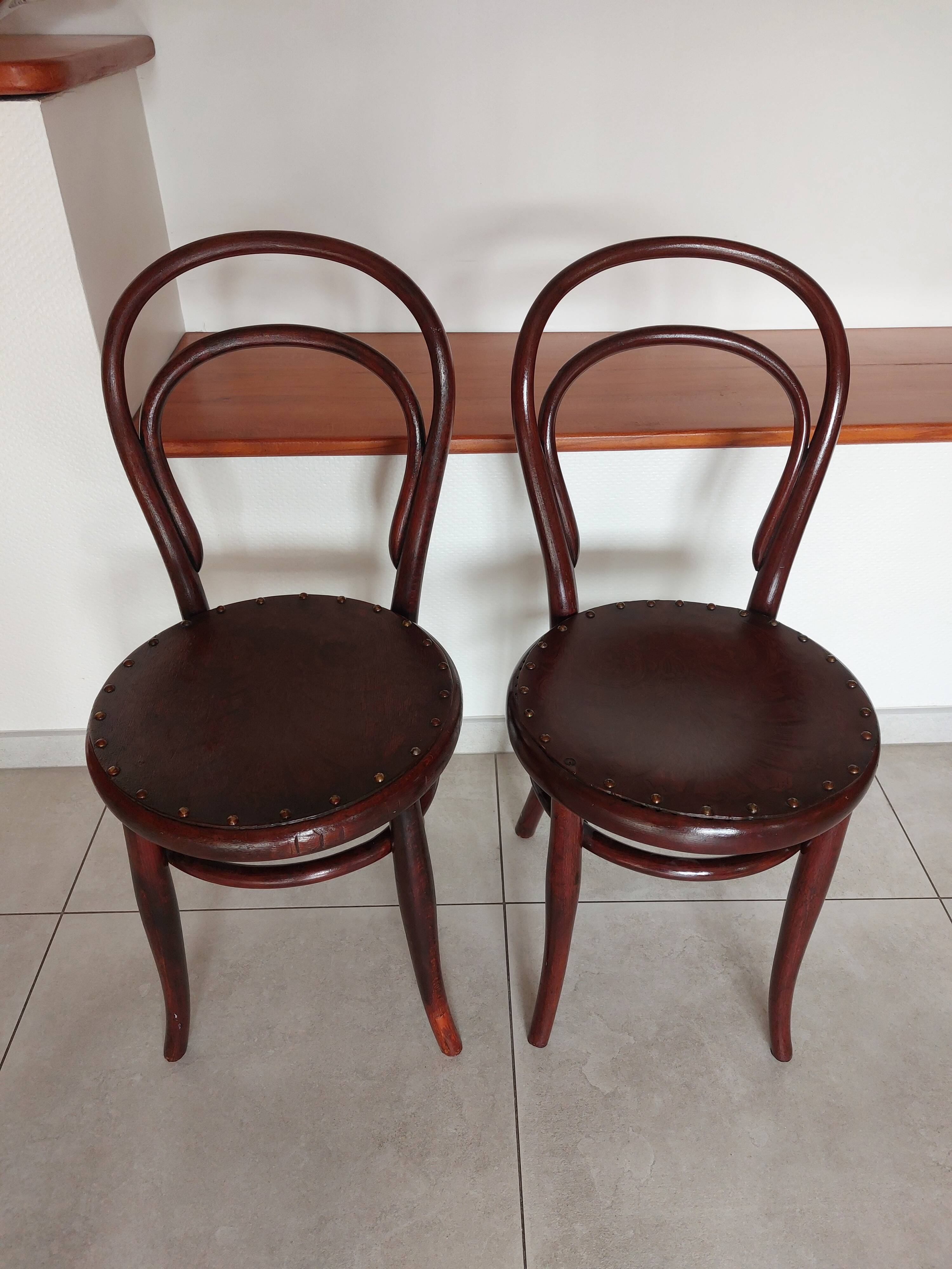 pair of round bistro chairs with a pattern on the seat, vintage
