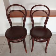 pair of round bistro chairs with a pattern on the seat, vintage