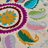 White suzani kilim rug with embroidered multi-colored patterns