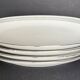 4 small oval porcelain dishes