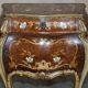 Pair of curved walnut commodes with marquetry and marble tops.