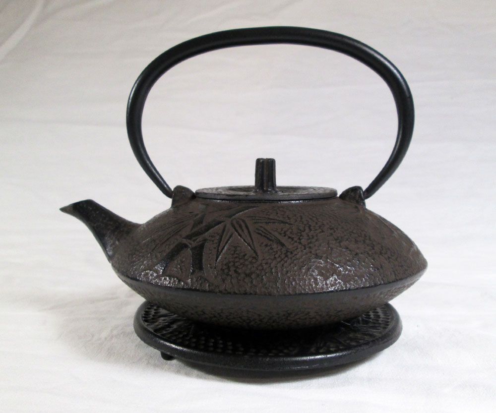 Antique cast iron teapot decorated