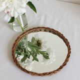 Decorative mirror tray surrounded by vintage rattan / wicker