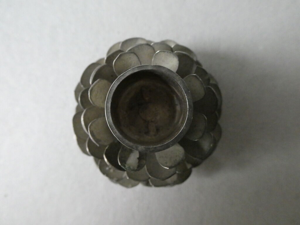 Silver-coloured metal pine cone candlestick