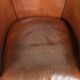 Vintage sheepskin club armchair with a warm colour scheme with black piping