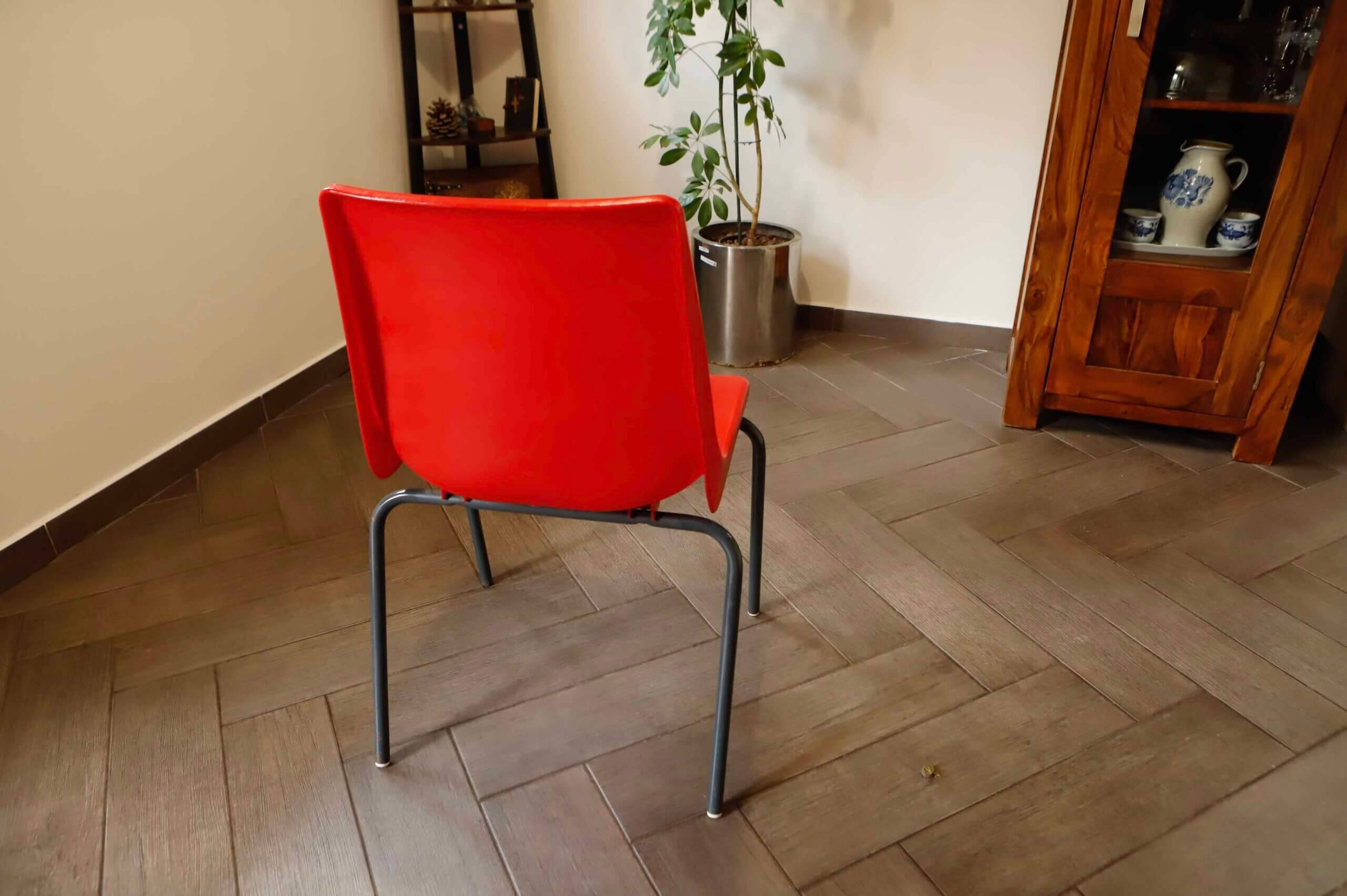 Pair of red plastic chairs with metal frame