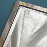 Faceted modernist wall mirror in steel and brass, geometric mixed metal frame 1970s.