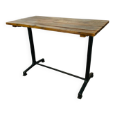 Bistro table with a cast iron base and wooden top.