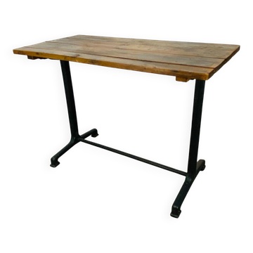 Bistro table with a cast iron base and wooden top.
