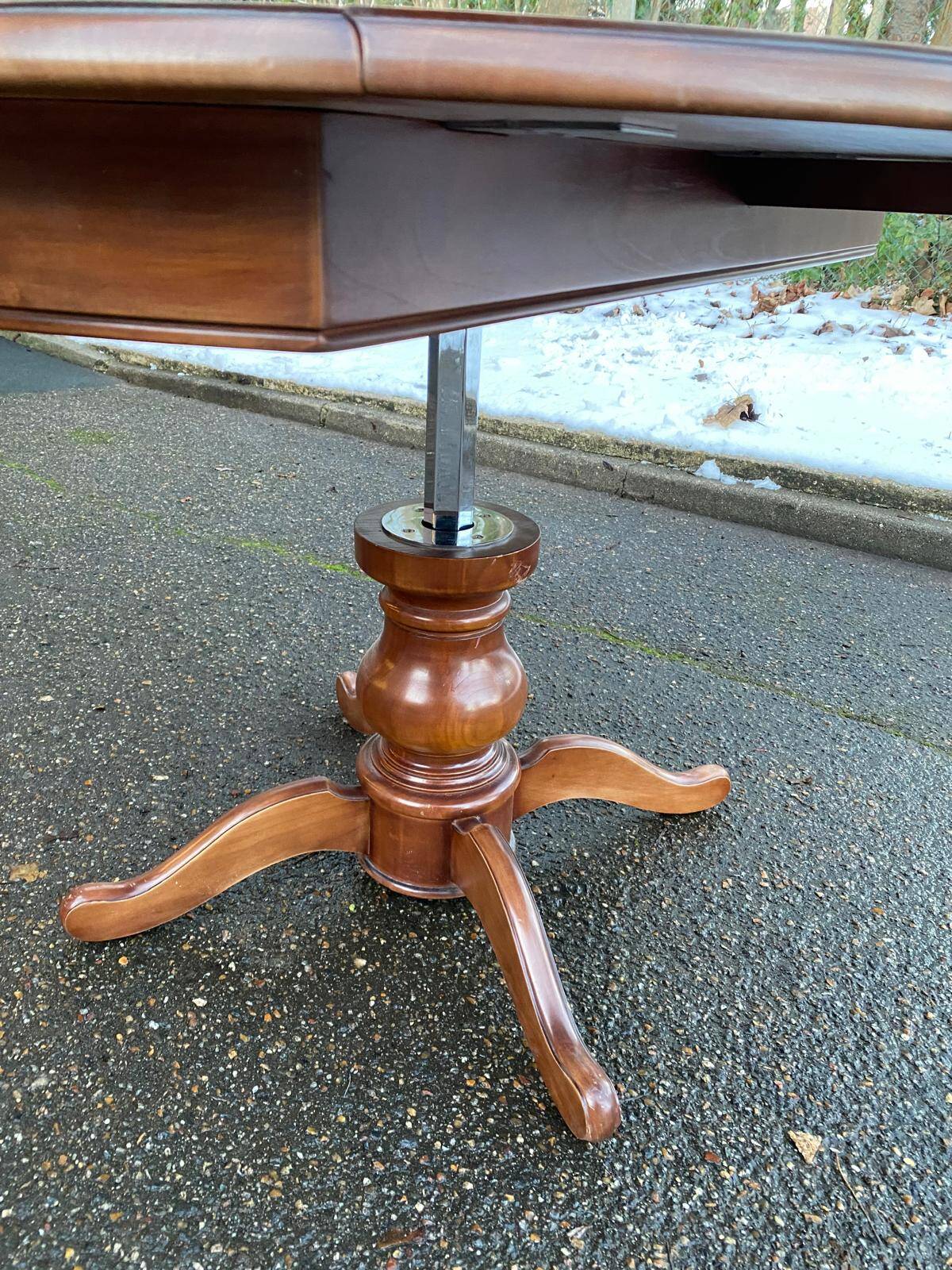 Round dining table, solid wood, central leg, extendable flaps, 20th century.