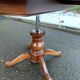 Round dining table, solid wood, central leg, extendable flaps, 20th century.