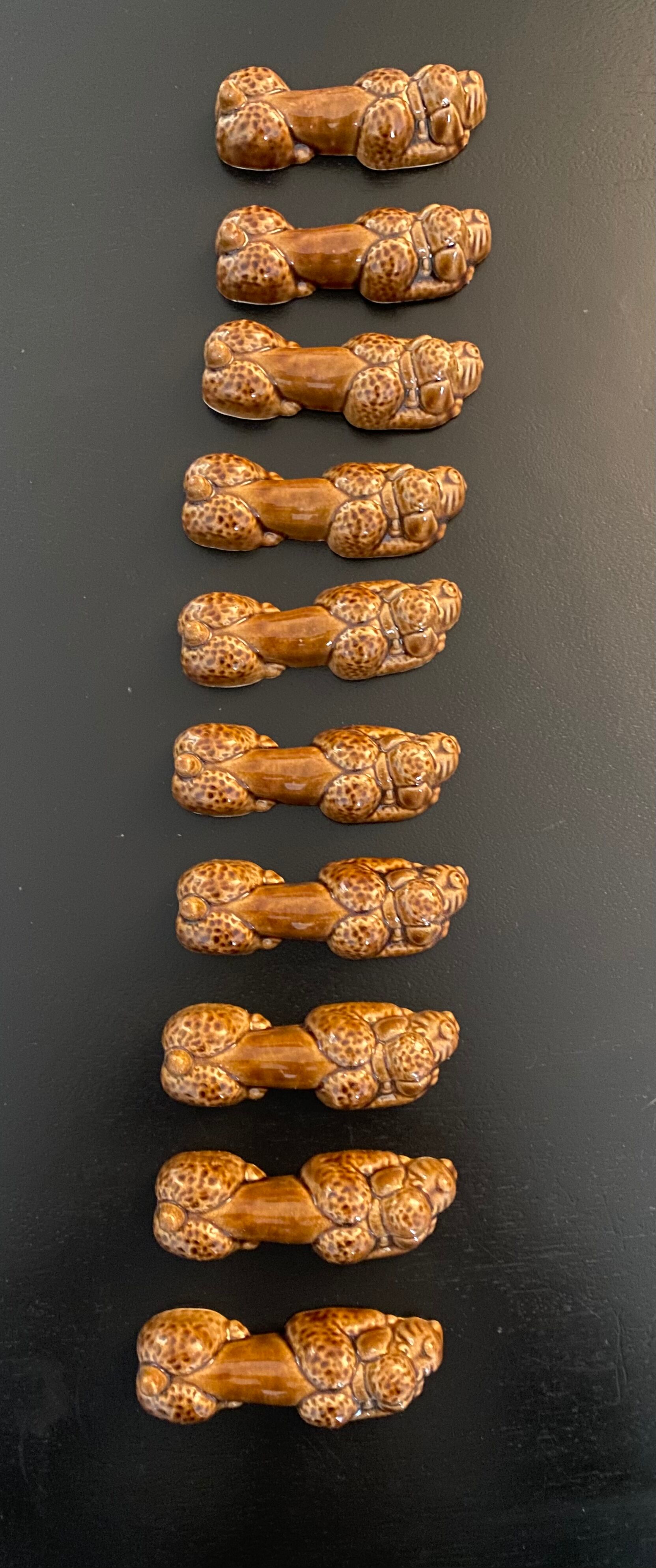 10 ceramic knife holders in the shape of a recumbent poodle