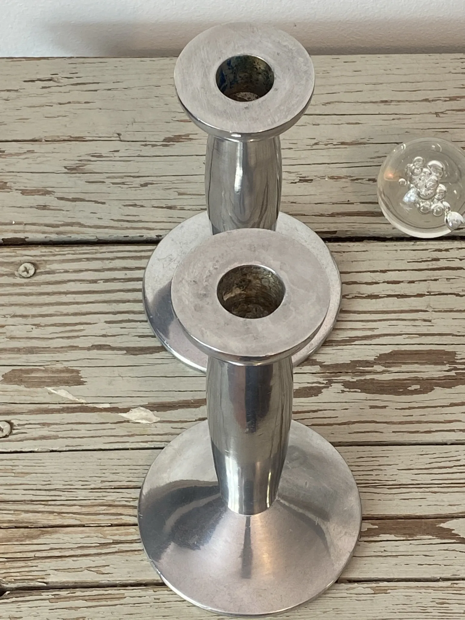 Pair of minimalist polished aluminium candle holders