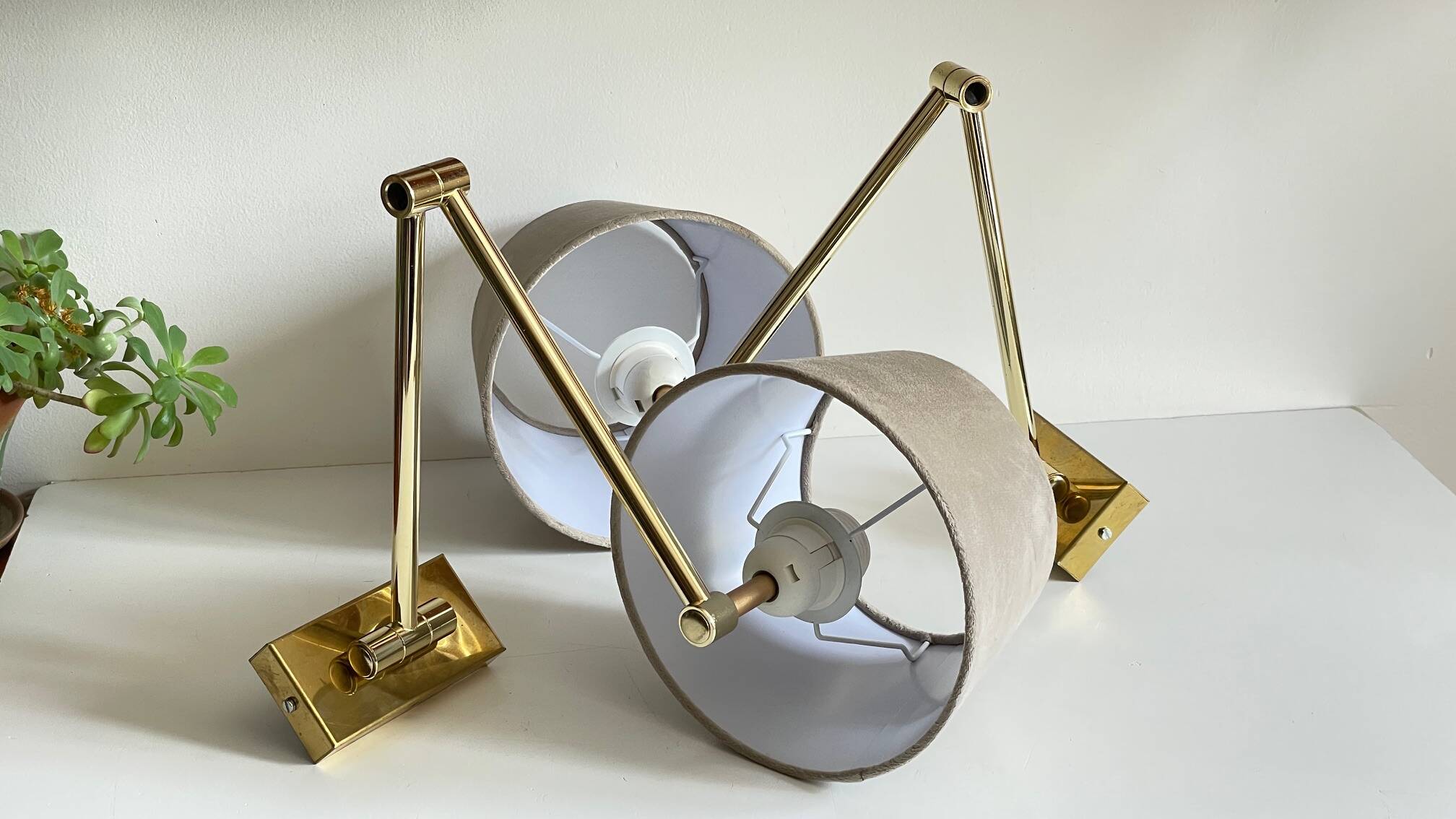 articulated brass and velvet wall light