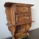 Small antique wall shelf with a drawer in light solid wood.
