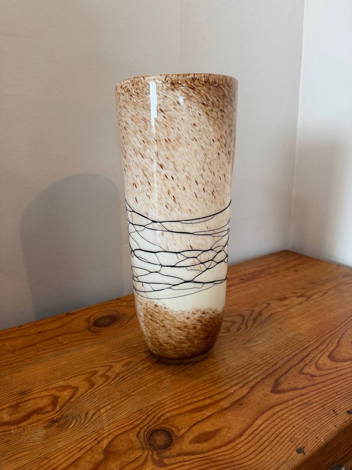 Large hand-blown glass vase in brown and beige.
