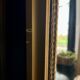 Large antique beveled mirror in the Napoleon III style - Gold and black frame