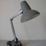 Super Chrome old articulated metal desk lamp on workshop decor base