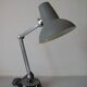 Super Chrome old articulated metal desk lamp on workshop decor base