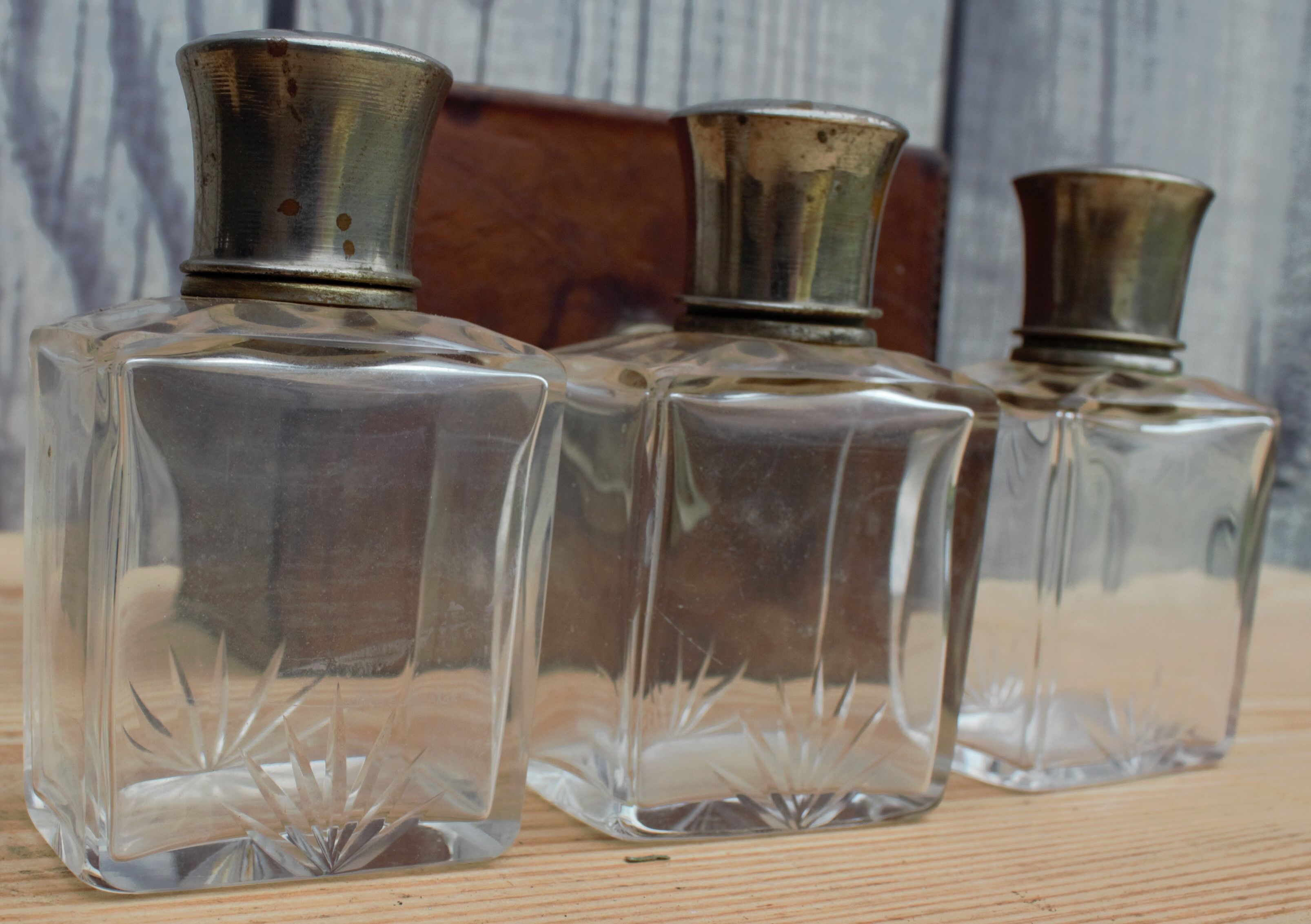 Antique leather case with 3 beveled bottles