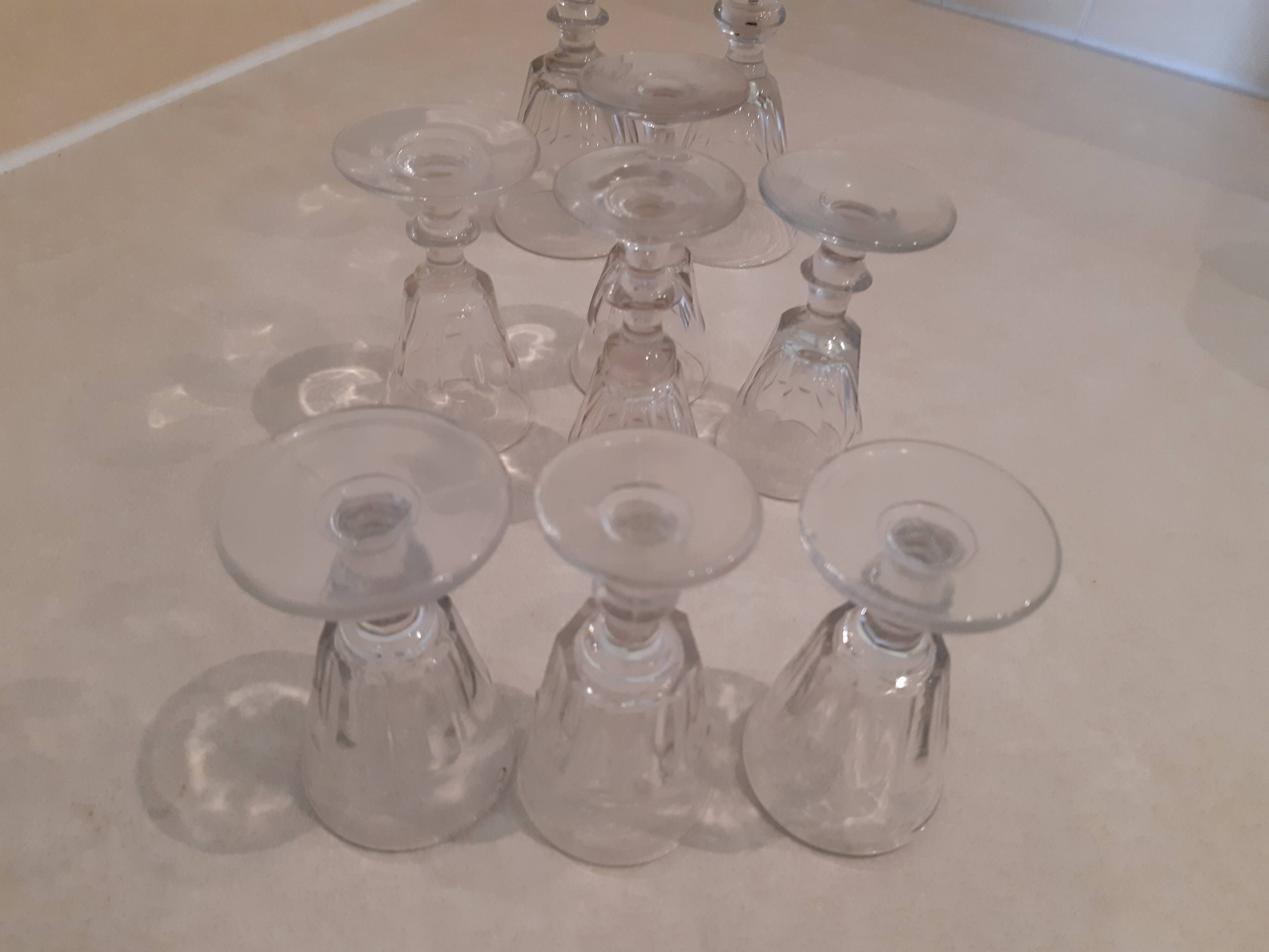 Set of 9 small cut glass stemmed glasses from the 1930s, in various sizes.