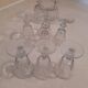 Set of 9 small cut glass stemmed glasses from the 1930s, in various sizes.