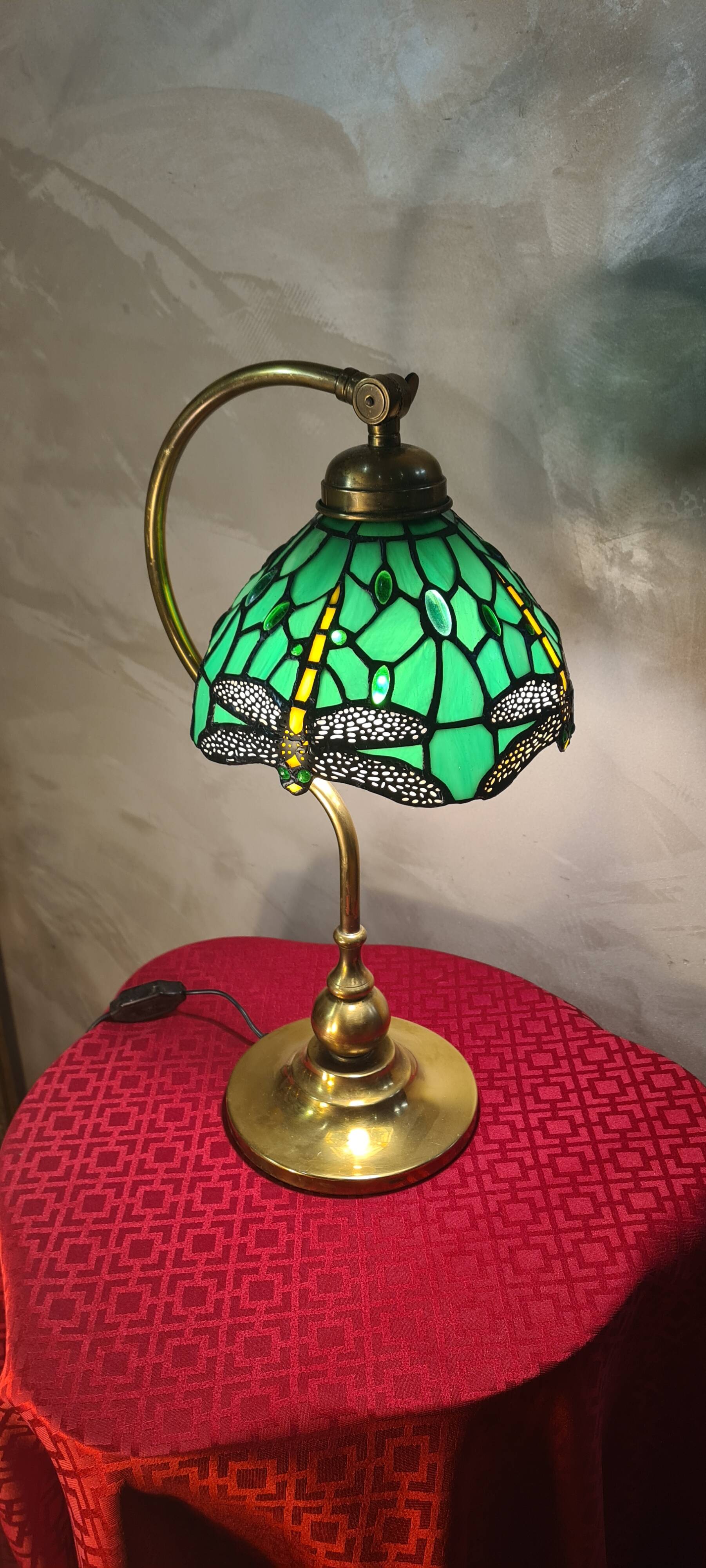 brass lamp with green stained glass shade.