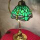brass lamp with green stained glass shade.