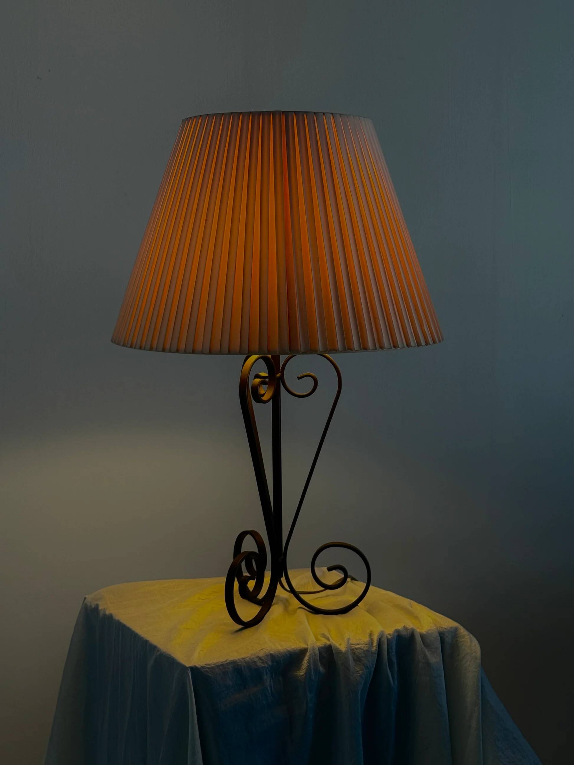 Vintage wrought iron table lamp in swirl shape with pleated shade
