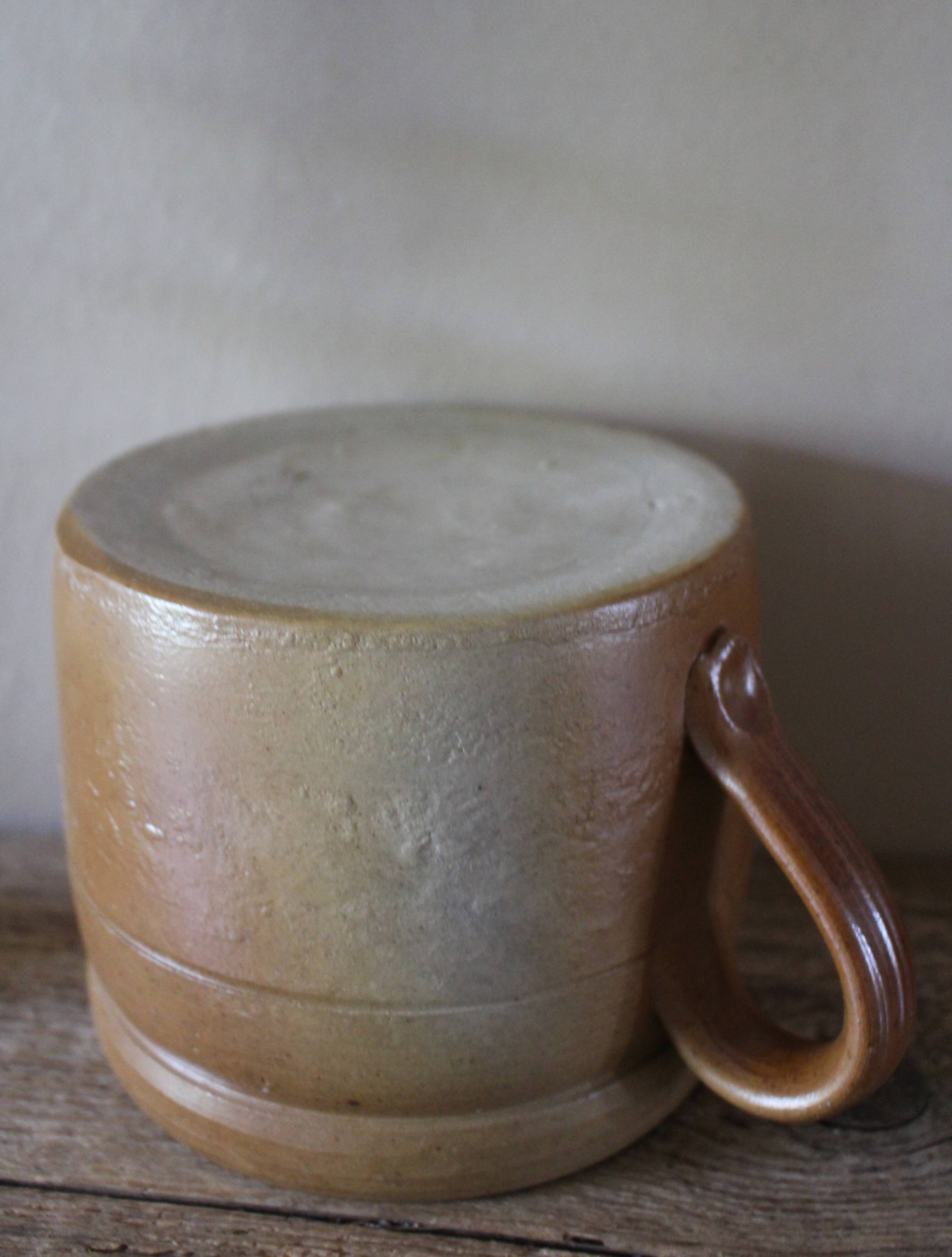 Vase terracotta milk jug with a glazed interior handle.