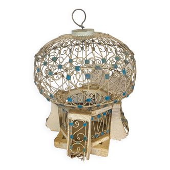 Old oriental style bird cage in metal and wood round shape