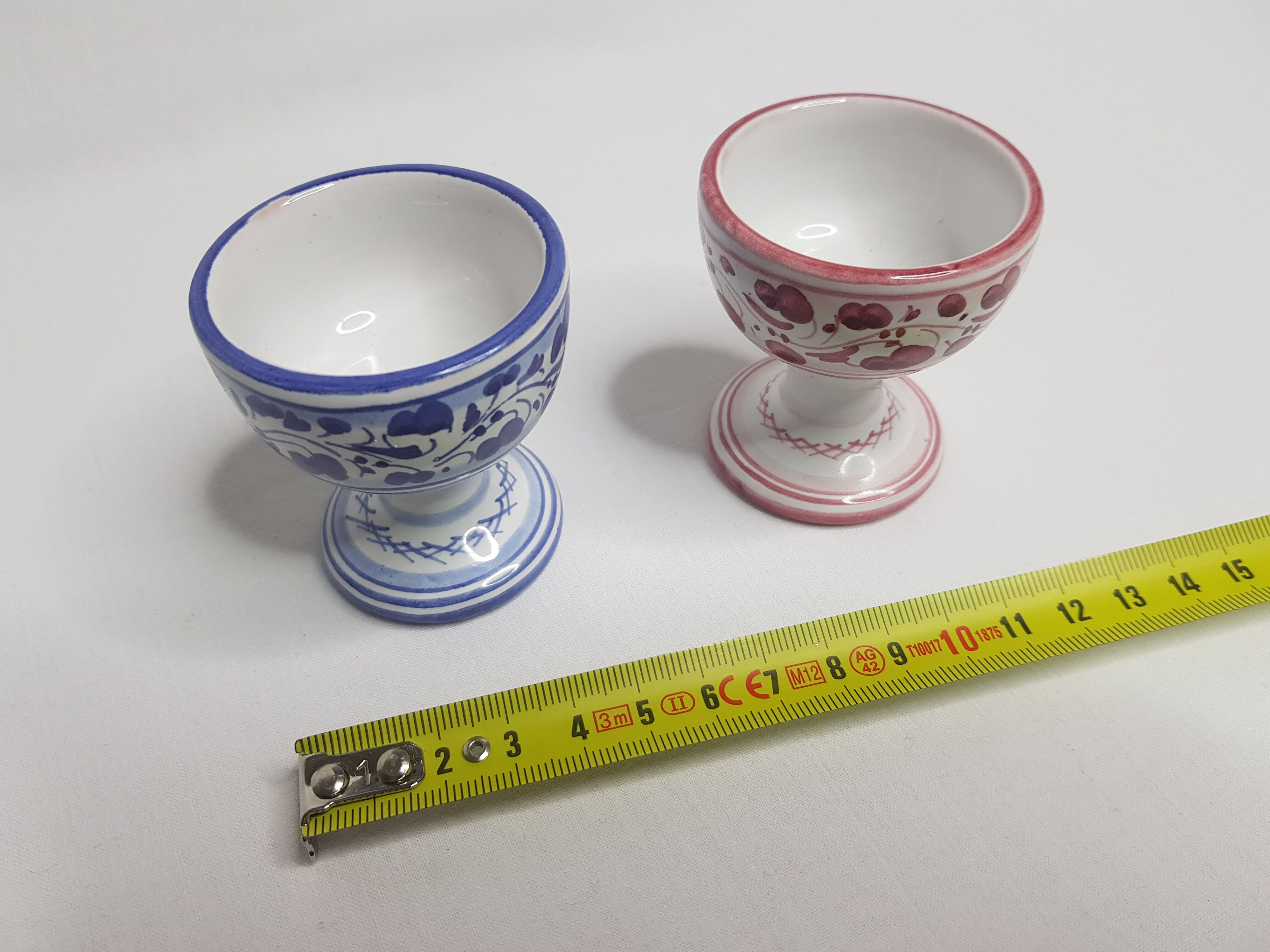 Pair of hand-decorated blue and garnet cockroaches signed "Siena Italy"