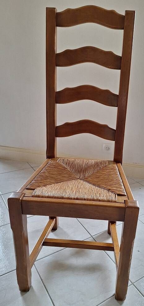 Set of 6 solid oak chairs with straw seats.