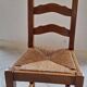 Set of 6 solid oak chairs with straw seats.