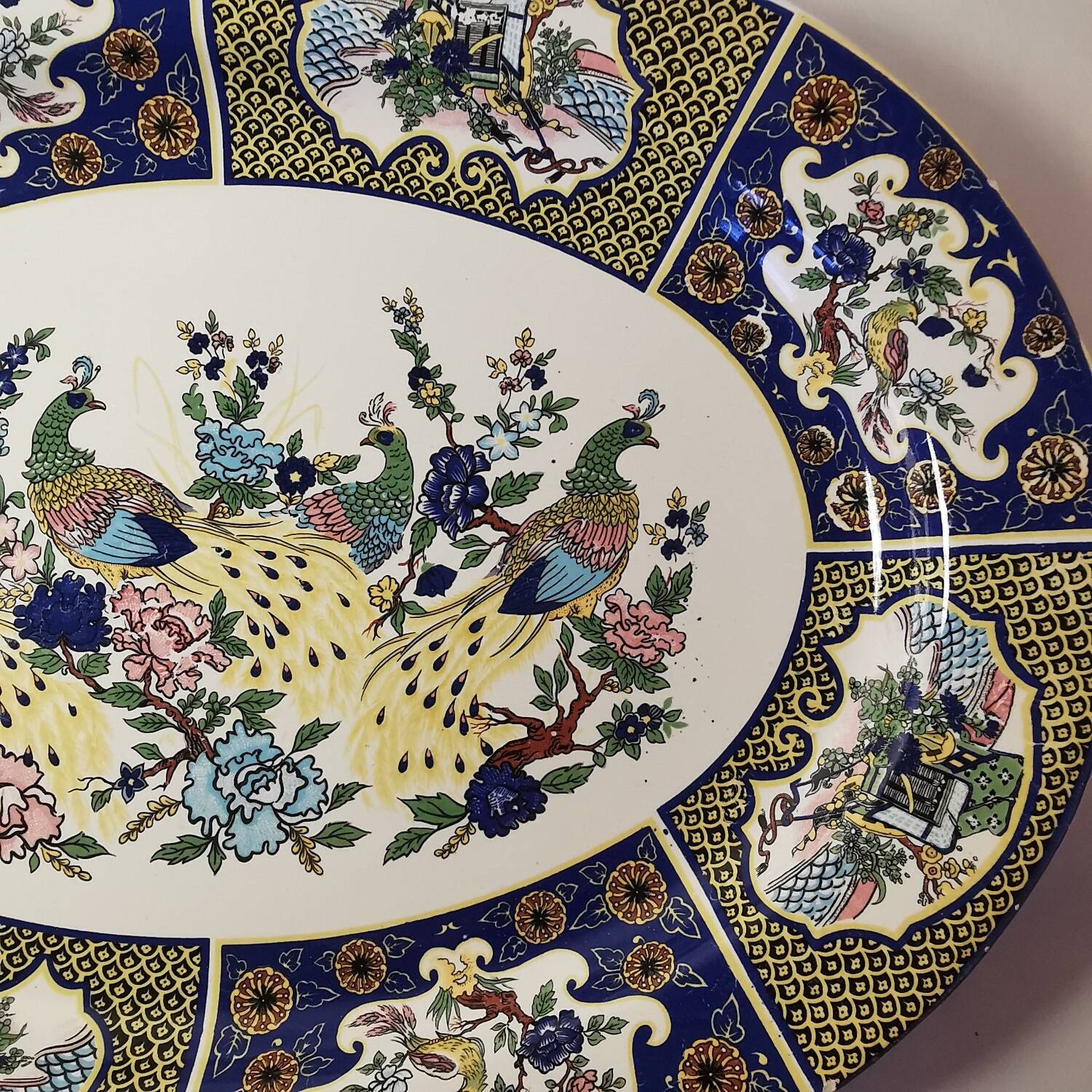 Ceramic dish decorated with peacock folk art Asian motif