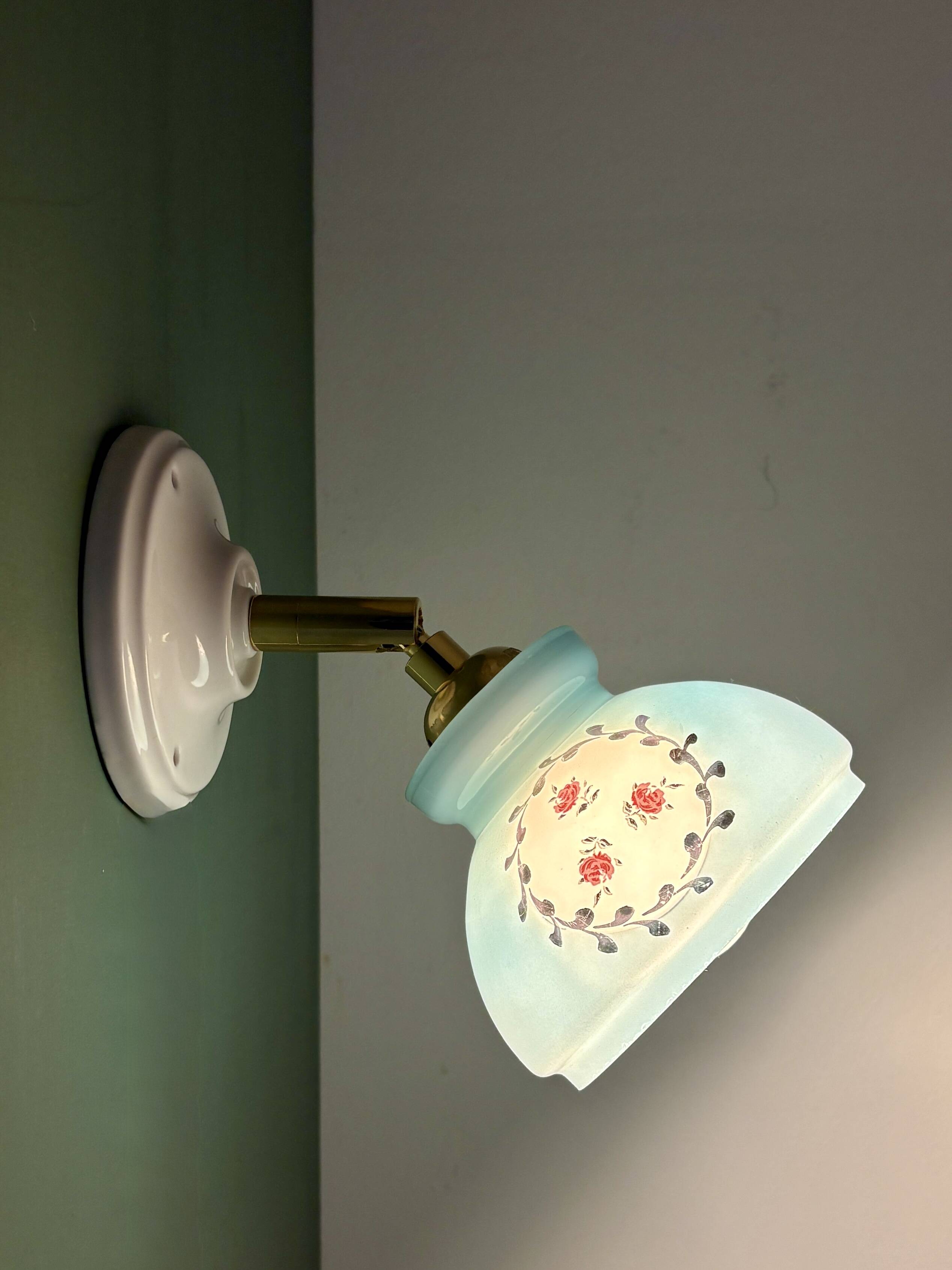 Vintage wall sconce with blue opaline glass shade and floral decorations