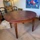 Oval extendable dining table in wood and walnut burl veneer.
