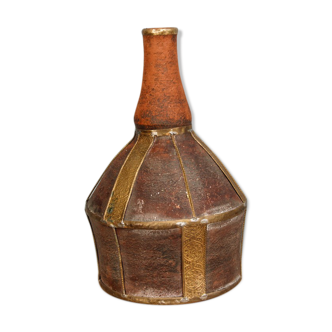 Old terracotta and brass bottle