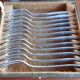 12 silver-plated metal condiment forks for shellfish by Christofle, Albi model.