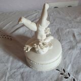 Small round box topped with a vintage biscuit porcelain angel